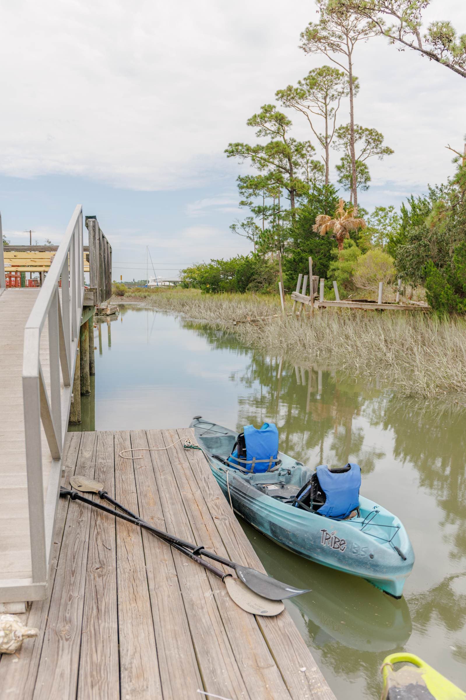 Kayak tied at the dock beside the tidal creek
