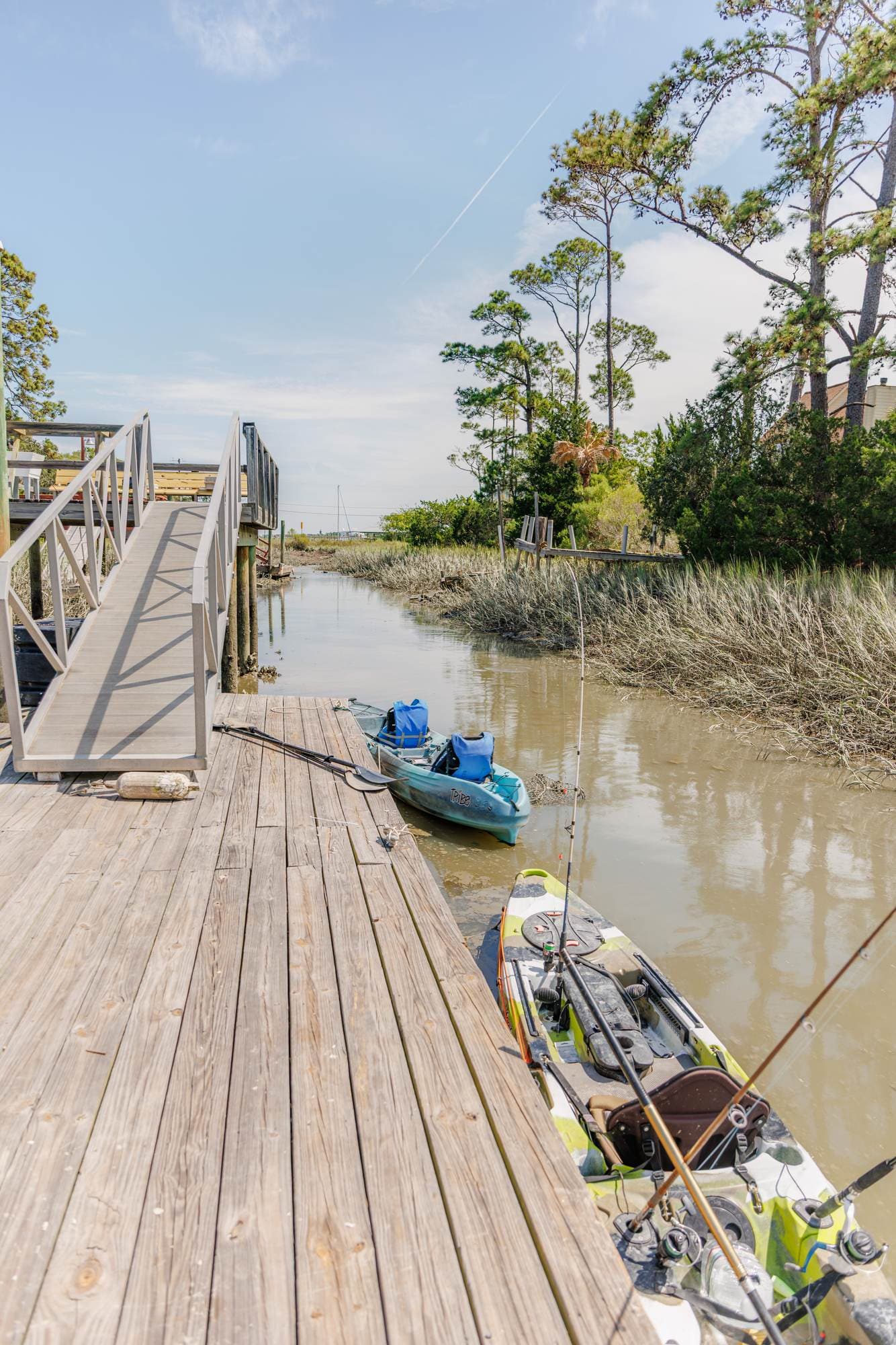 Two kayaks at the dock on the tidal creek