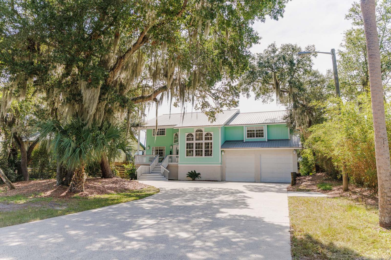 Live oaks with Spanish moss framing the house