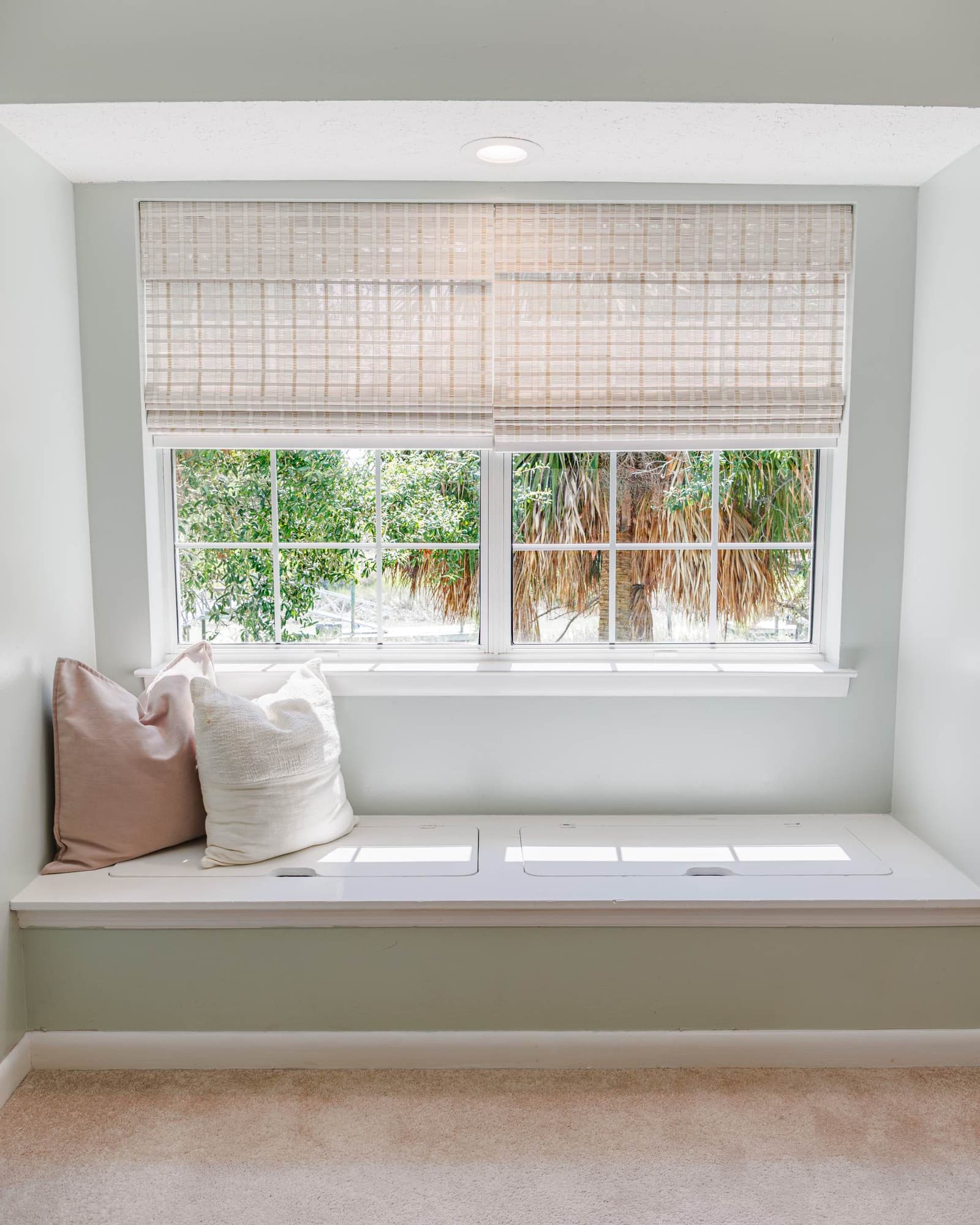 Window seat with pillows in the classic guest bedroom