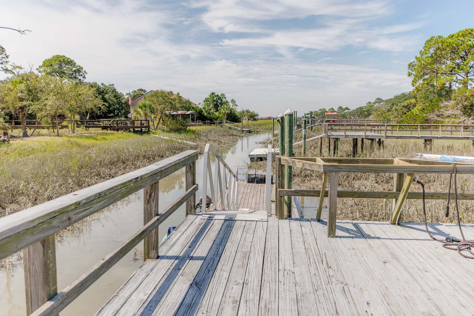 Dock and tidal creek with marsh grass on either side