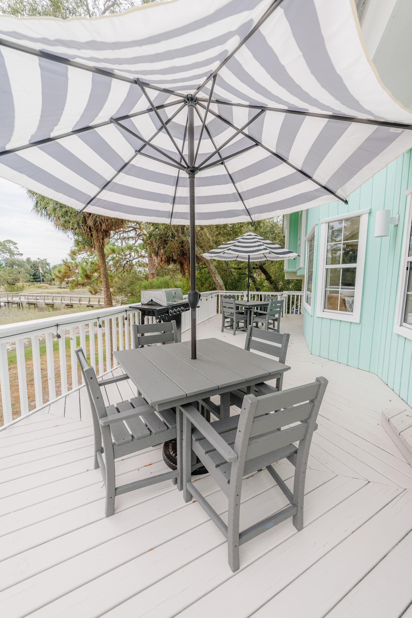 Back deck with dining table and umbrella