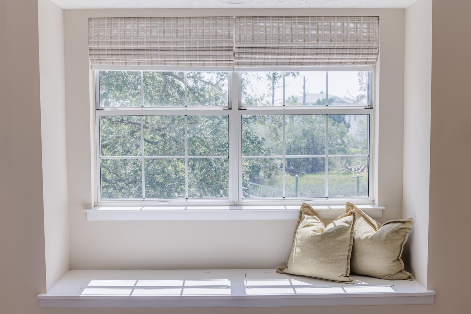 Primary suite window bench with cushions beneath two large windows