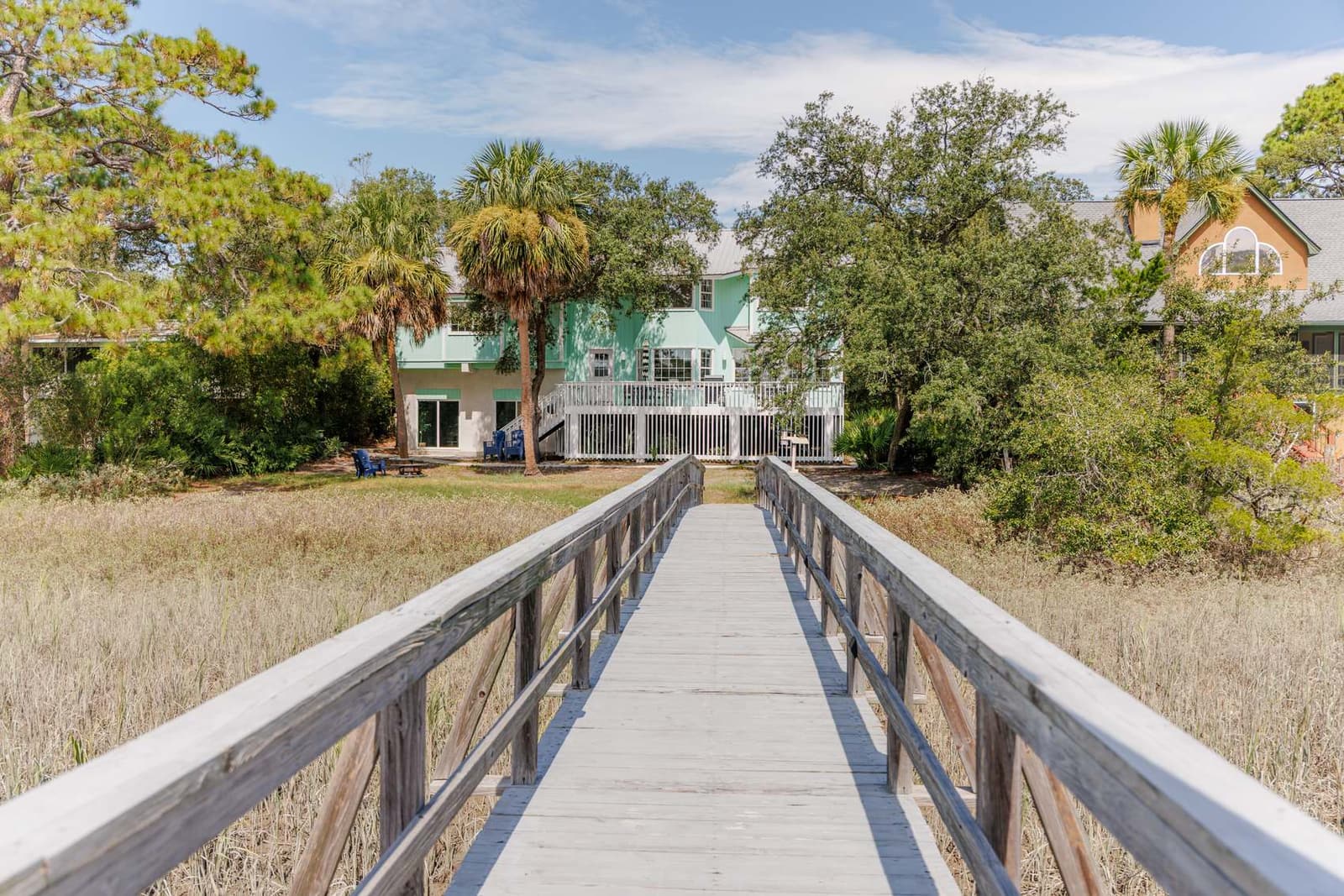 The Retreat at San Marco at golden hour, framed by live oaks